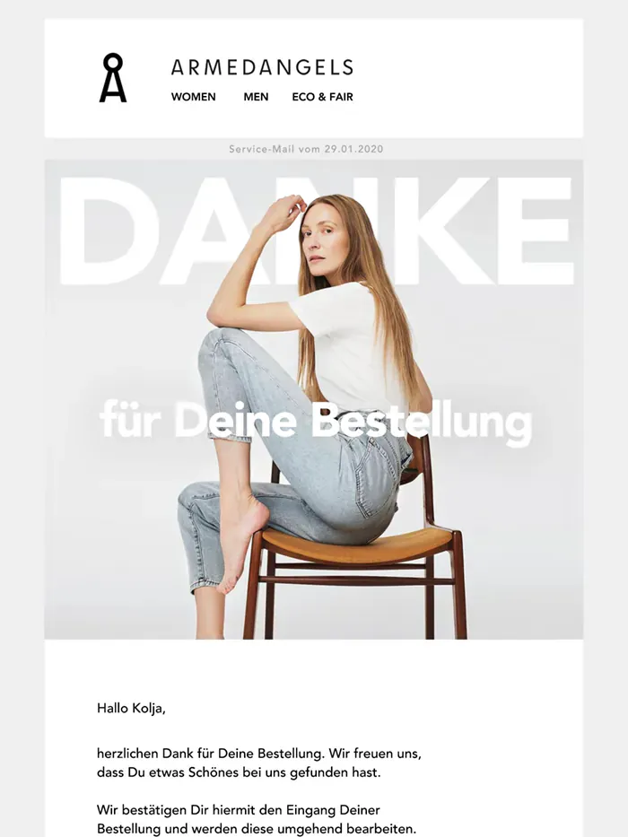 Armedangels order confirmation in German: “Danke” in giant white letters behind a woman in jeans on a wooden chair, then the order with a striped organic-cotton sweatshirt. The customer’s address is blurred.